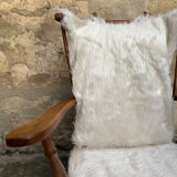 Scandinavian armchair in solid wood with beige fur cushion