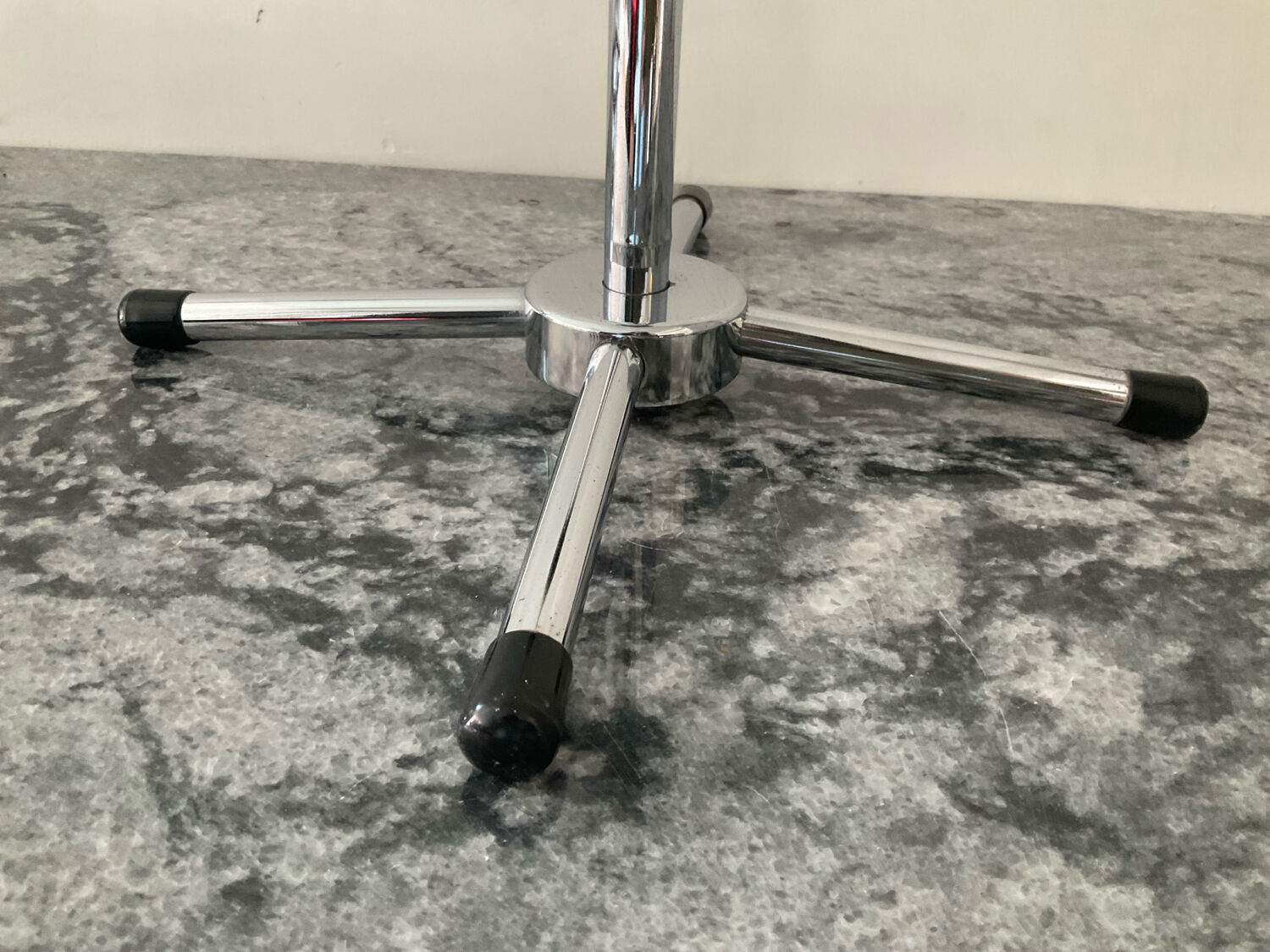 A pair of vintage side tables in glass and chrome metal.