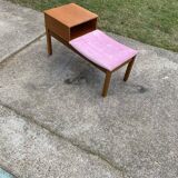 Mid-Century telephone bench in teak with bright pink fabric seat and wooden top.