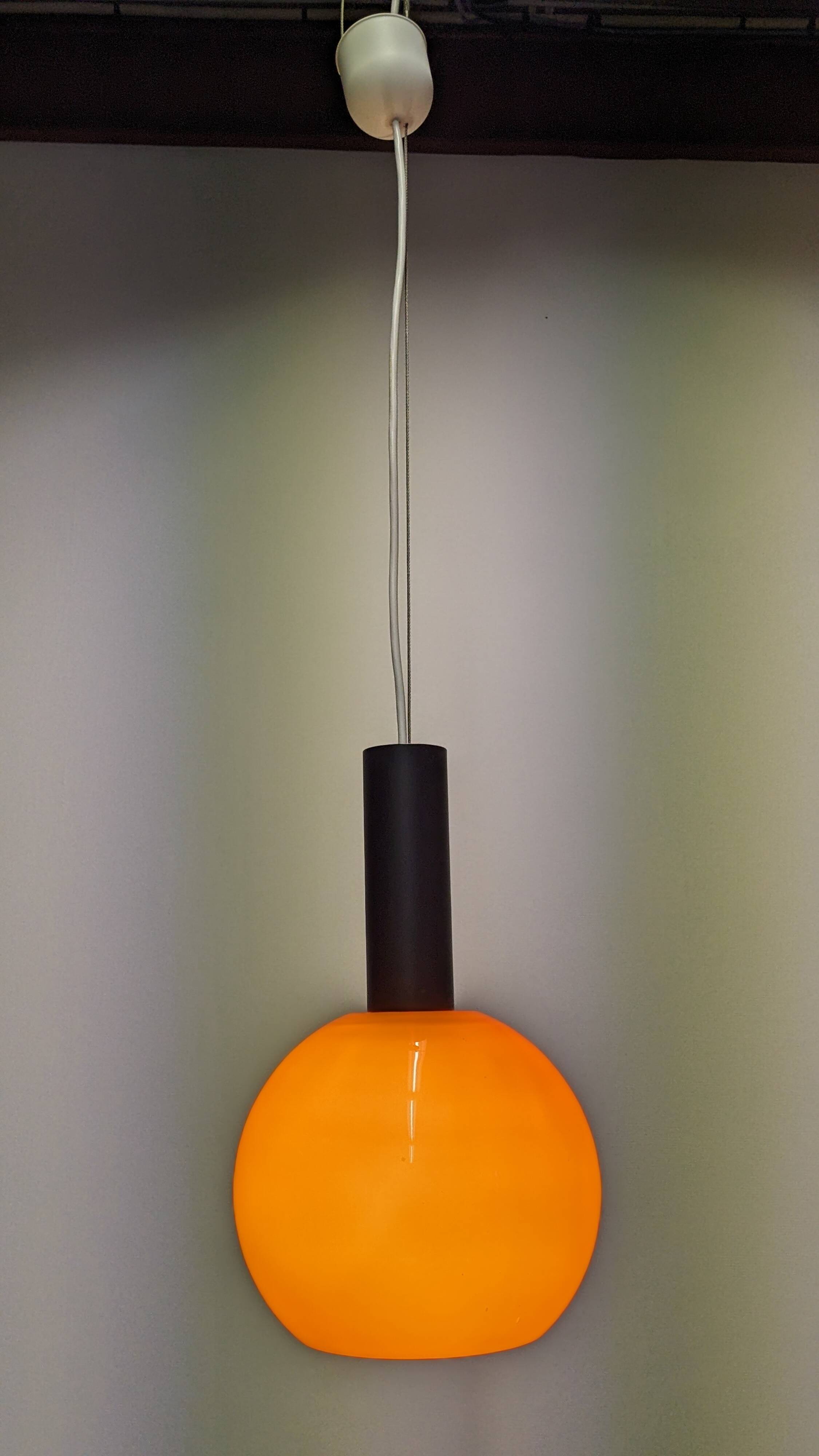 Pair of orange opaline ball pendants by Parscot, France circa 1970.