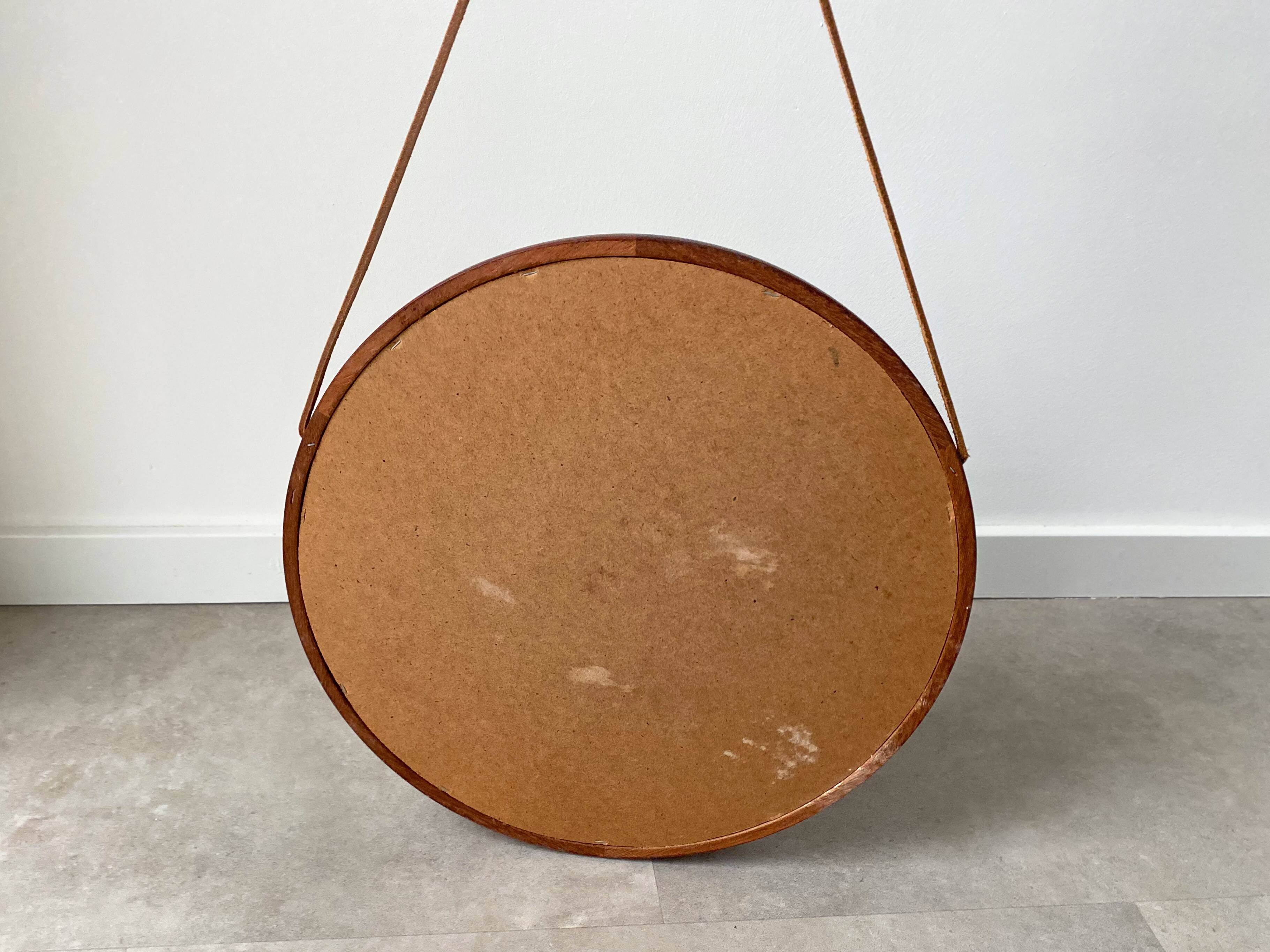 Mid Century solid teak wall mirror with a leather strap - Danish design