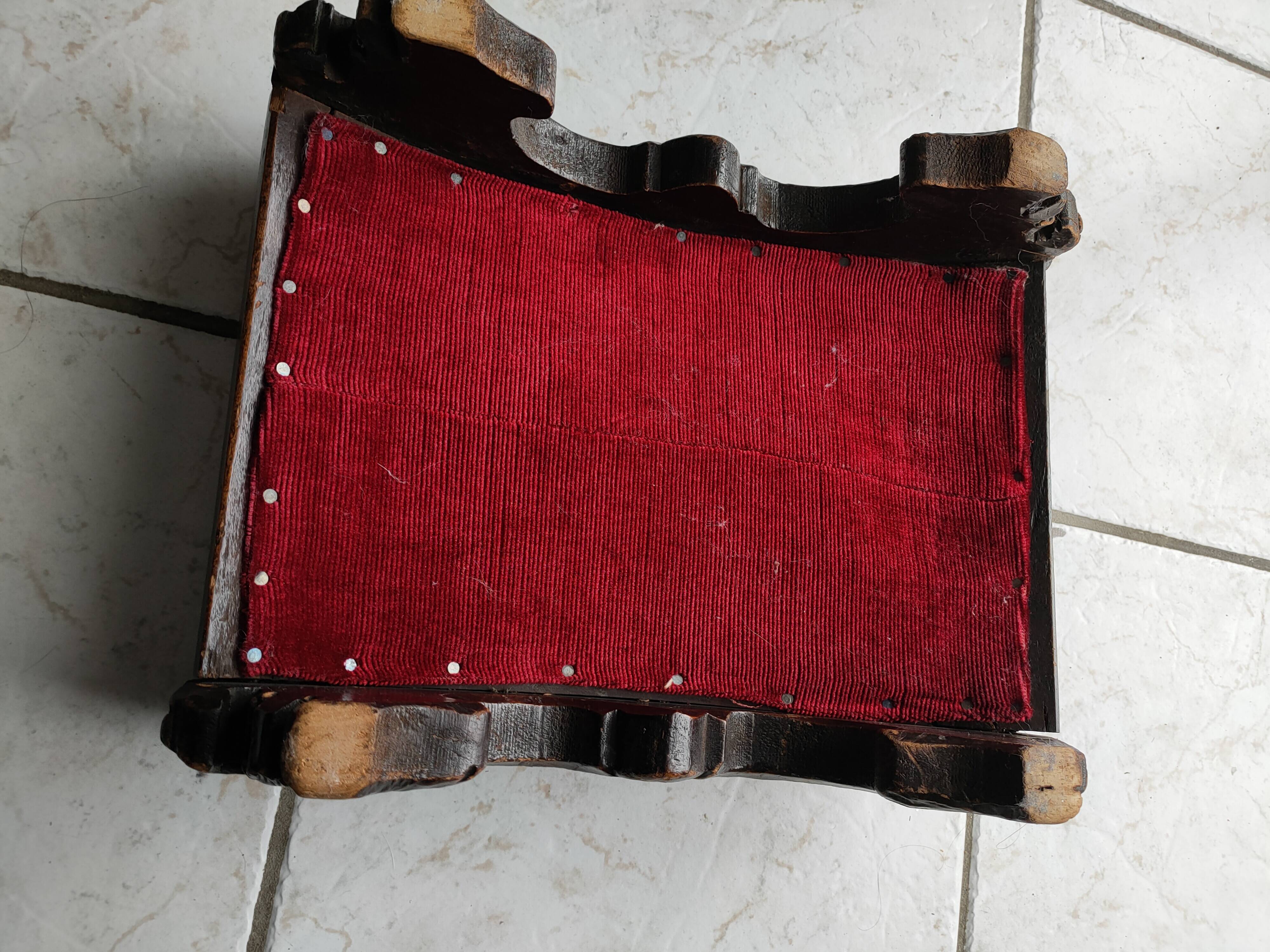 Red velvet footrest or prie-dieu