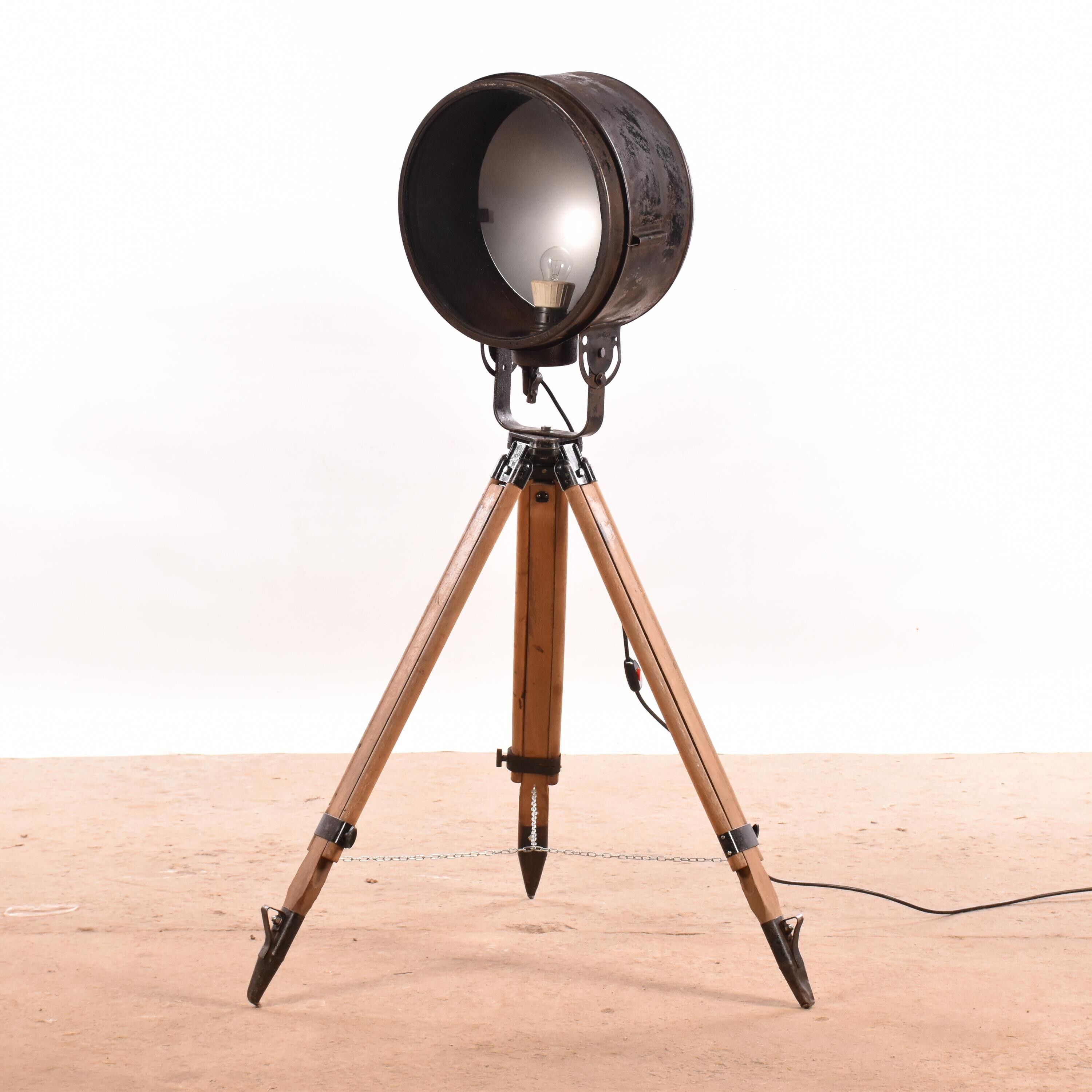 Old industrial spot on wooden tripod floor lamp