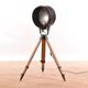 Old industrial spot on wooden tripod floor lamp