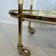 Italian oval rolling table in brass and lacquered wood.