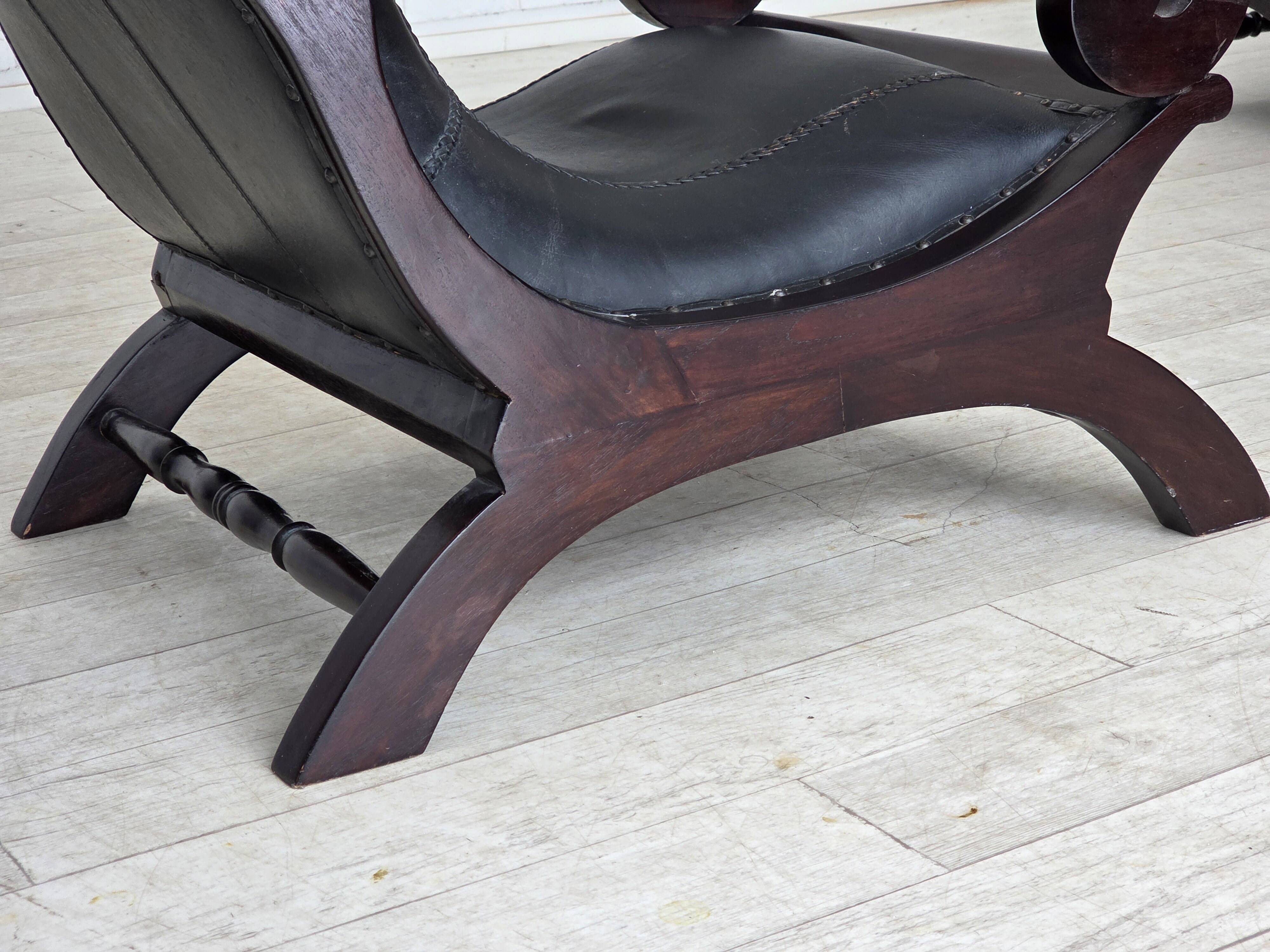 1970s, vintage armchair with footstool, black furniture leather.
