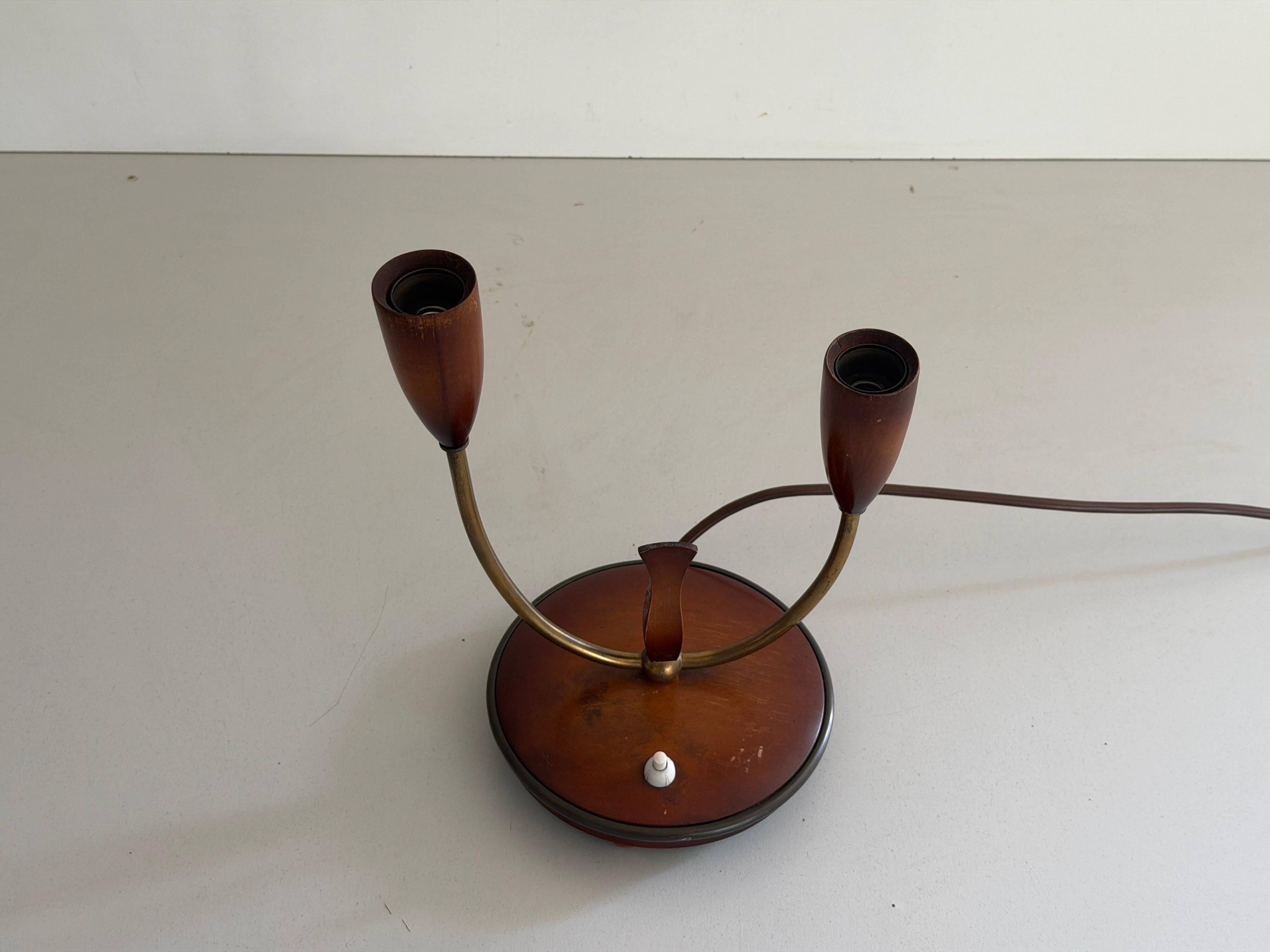 Simple double-headed table lamp in wood and brass, 1960s, Germany.