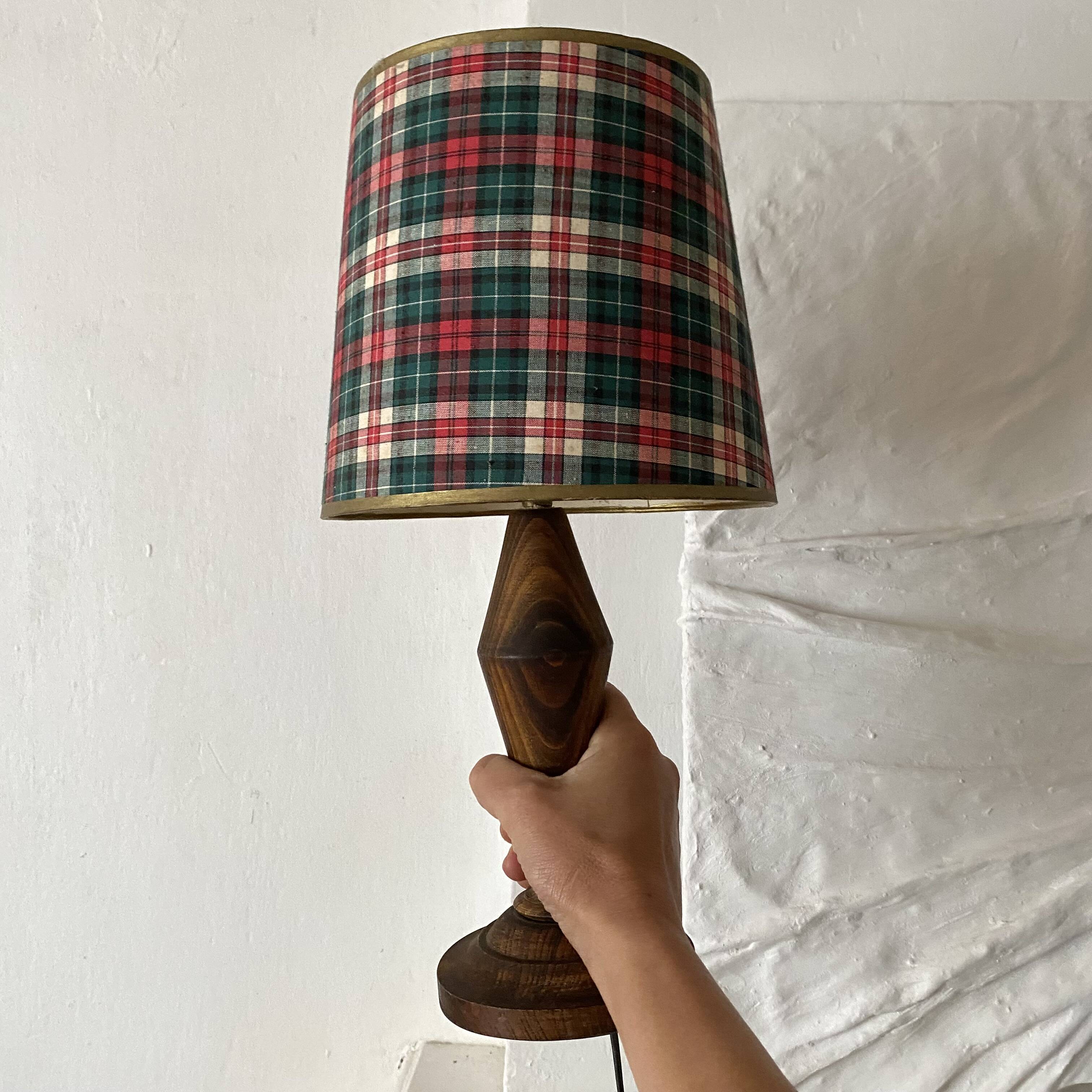 Turned wooden lamp, tartan lampshade.