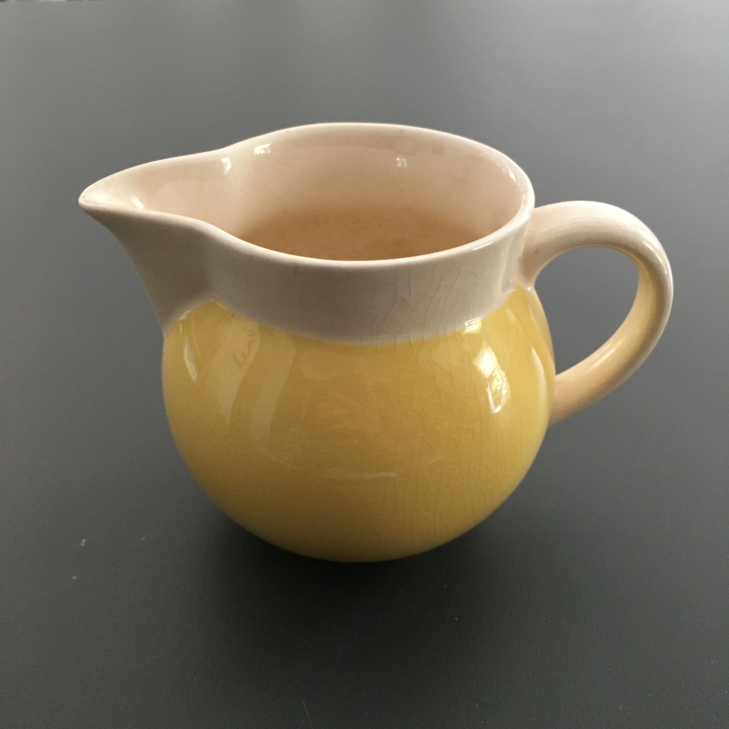 Yellow straw and ivory pitcher