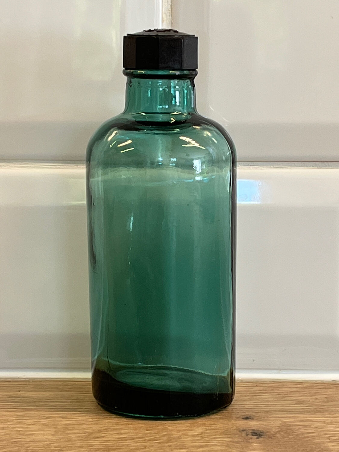 Small vintage dark turquoise blue bottle