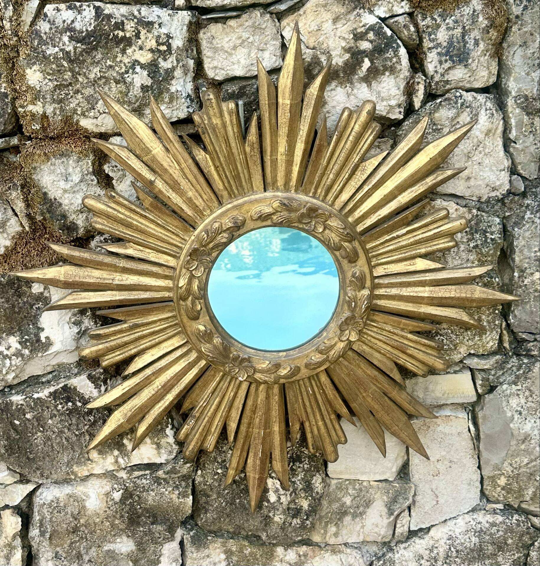 Large sun mirror in carved gilded wood.