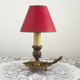 Vintage French bronze Wee Willie Winkie style lamp with red card shade.