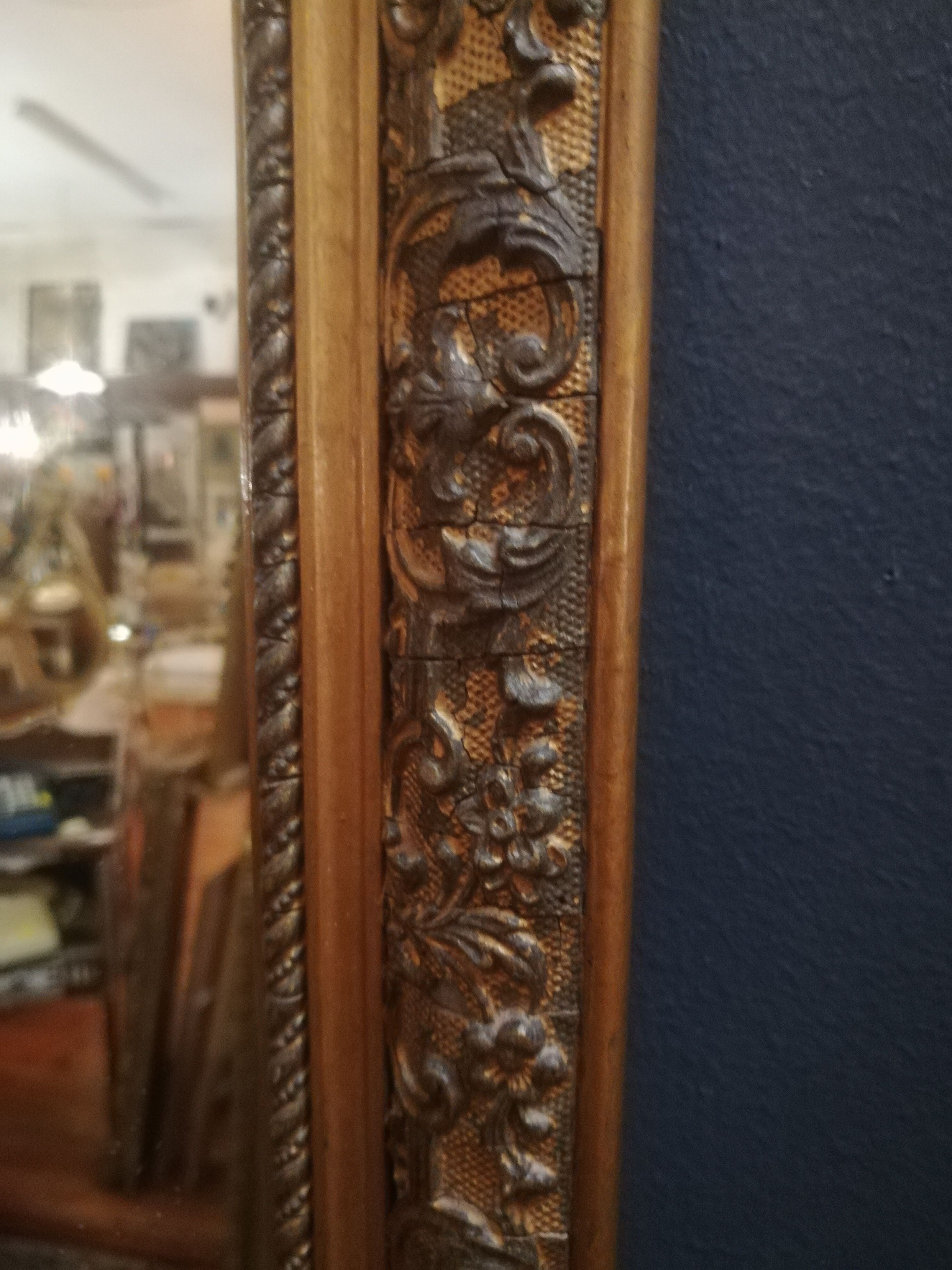 High and narrow mirror in gilded stucco late nineteenth century