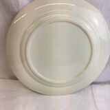 Old dish of ivory color and round shape with a chantourné edge.