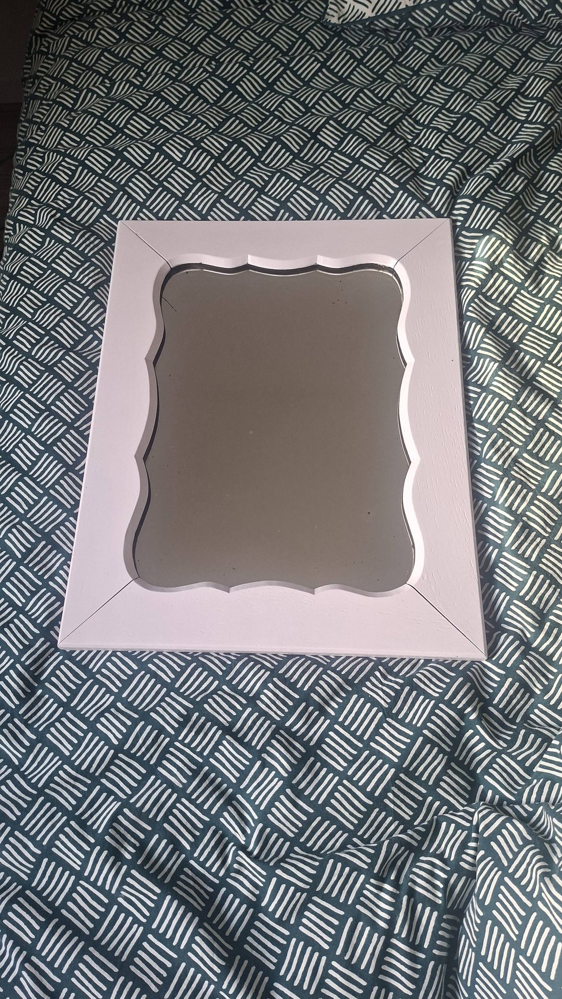 Mid-20th century rectangular wall mirror with a powder pink frame.