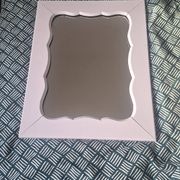 Mid-20th century rectangular wall mirror with a powder pink frame.
