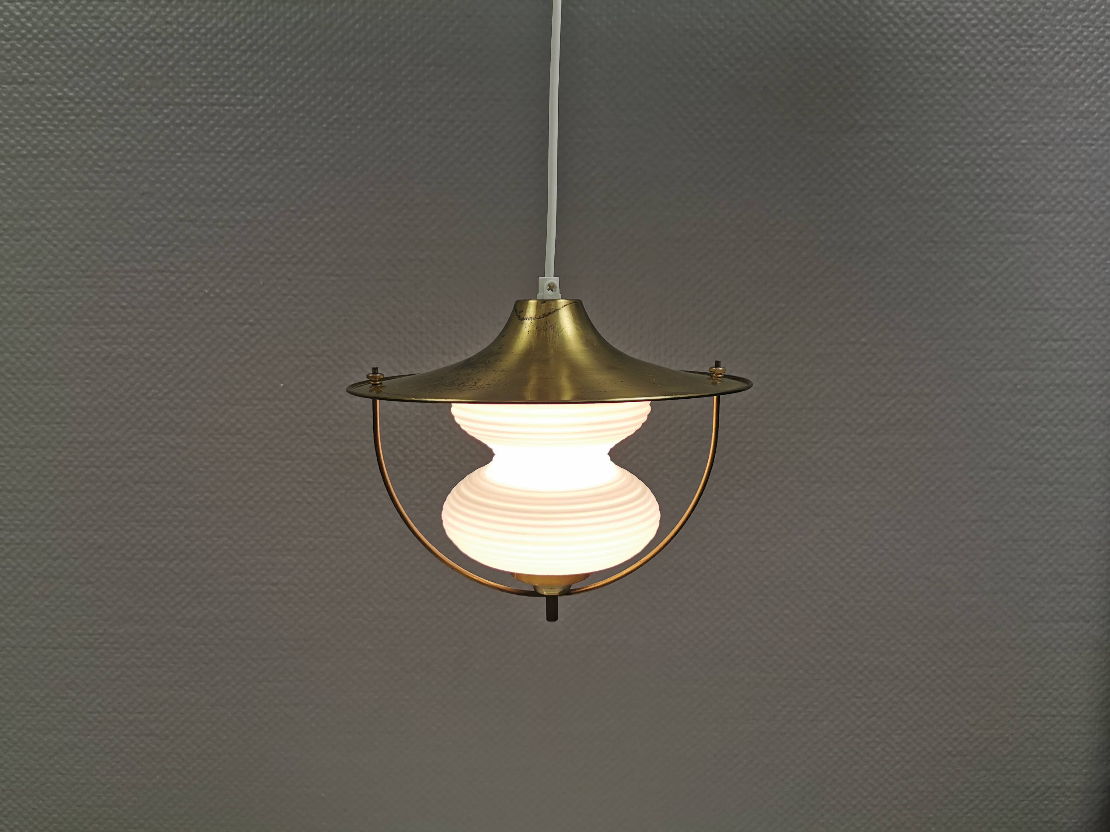 Beautiful older hanging lamp in brass and milky white glass. Germany 1950s