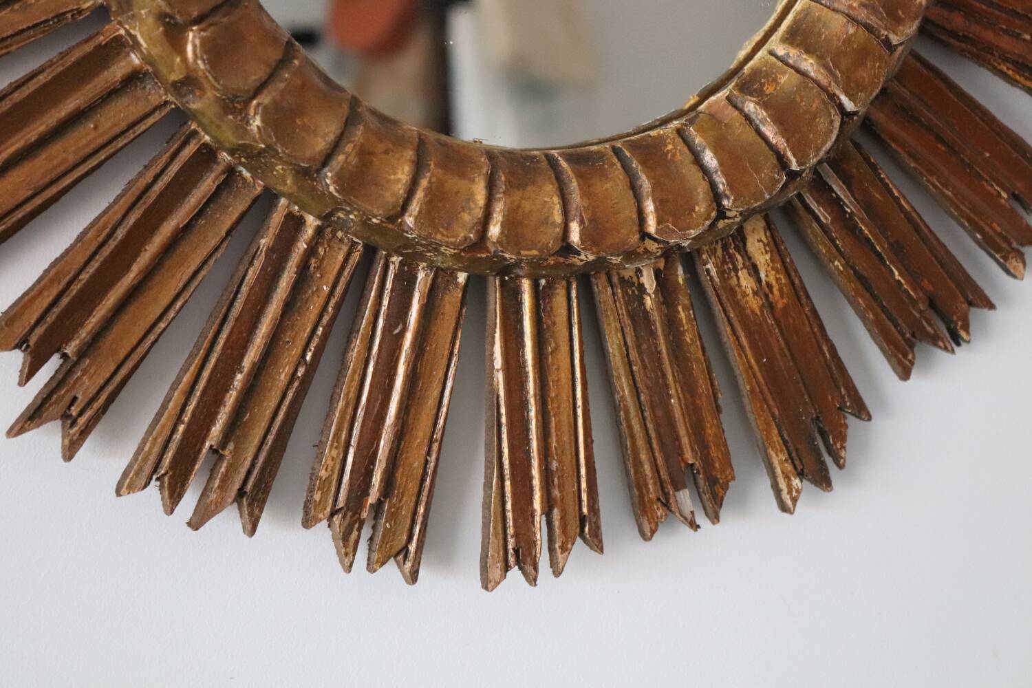 Old large sun mirror in gilded wood