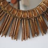 Old large sun mirror in gilded wood