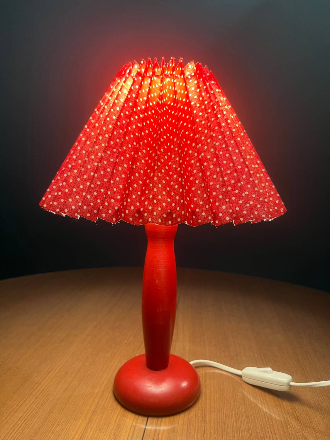 Wooden foot lamp with folded cardboard lampshade
