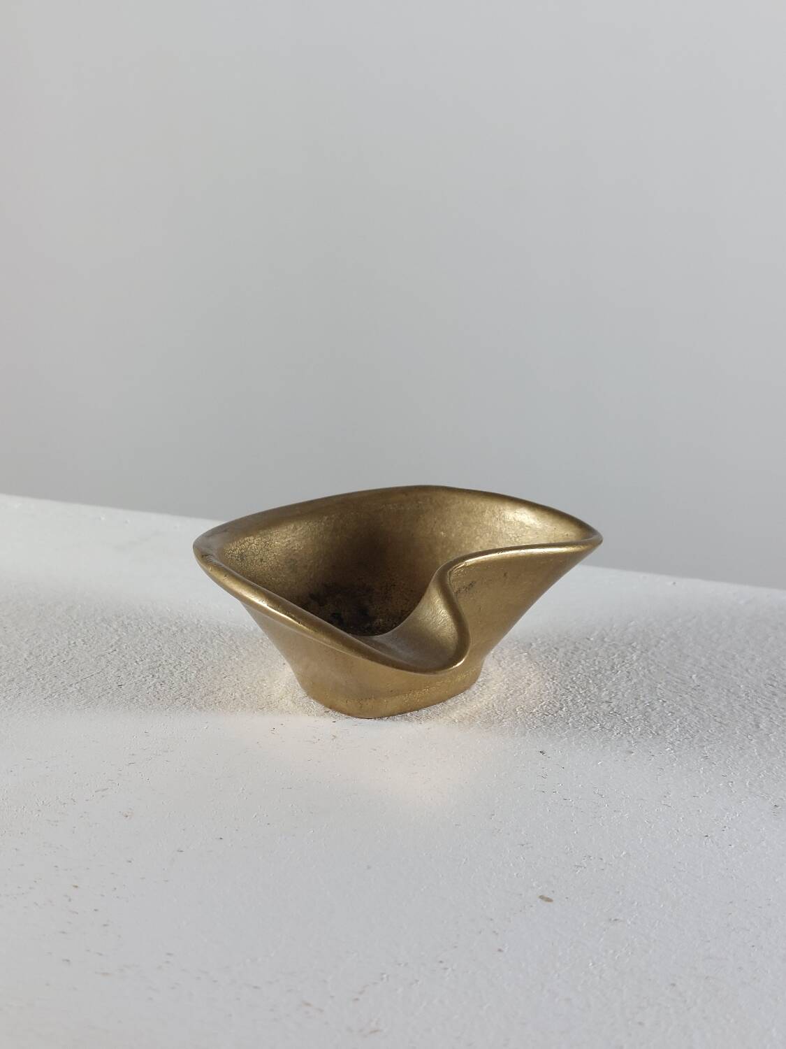 Vintage brass ashtray with an organic design from the 1950s.