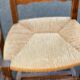 4 or 5 solid wood chairs with light oak straw and high backs