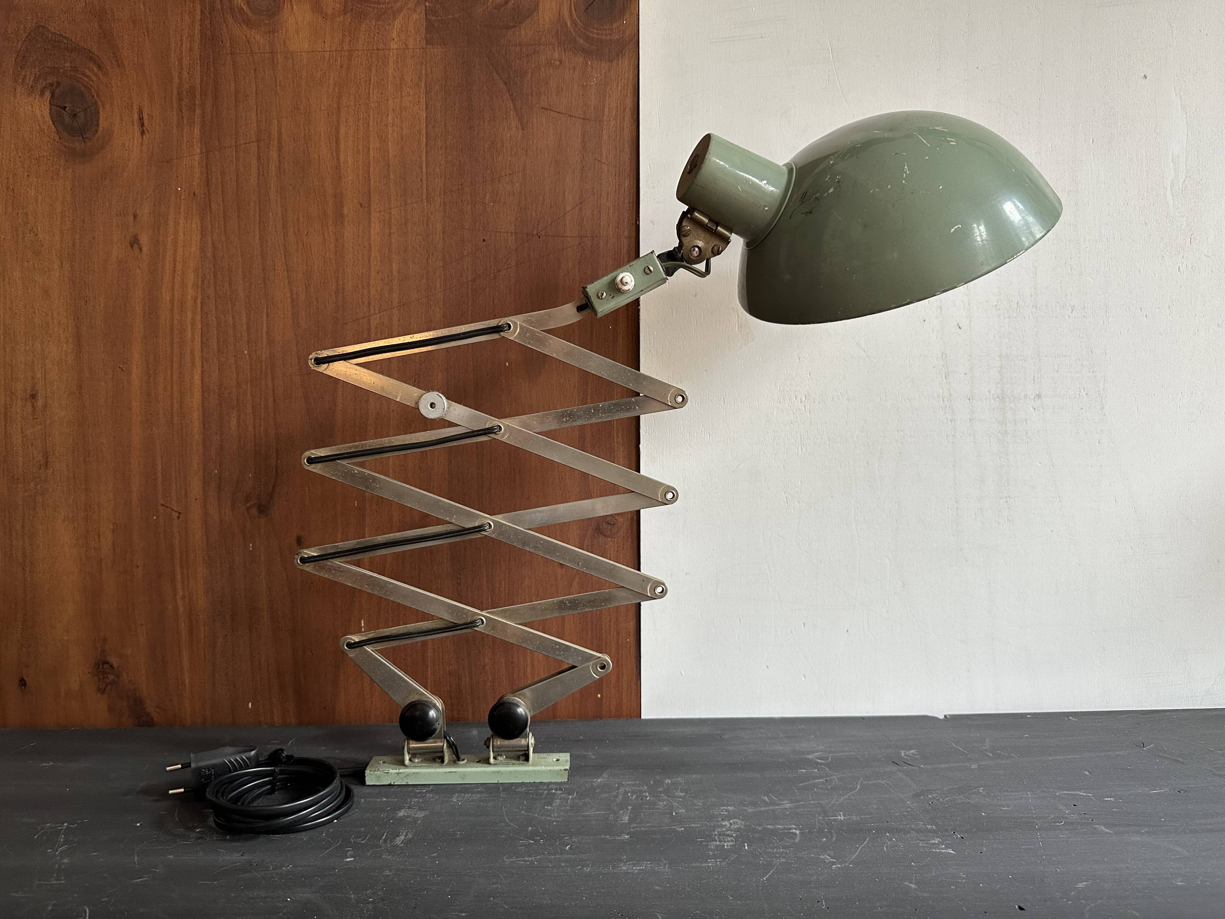 Old extendable accordion lamp in celadon green, workshop spirit.