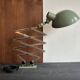 Old extendable accordion lamp in celadon green, workshop spirit.