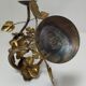 Pair of brass candle holders decorated with patinated metal flowers