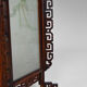 Asian wooden lantern carved with dragons and painted glass panels