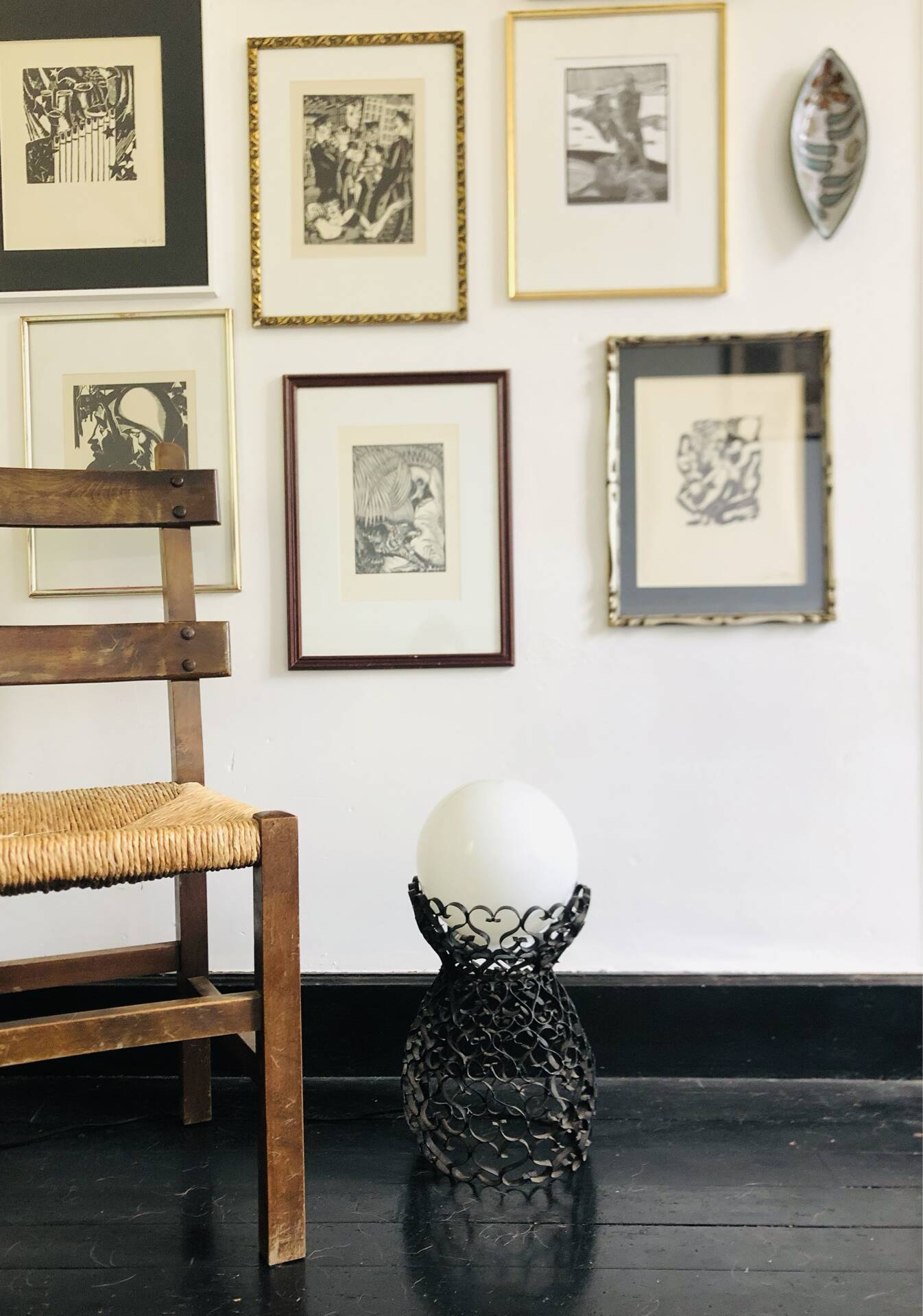 Handcrafted wrought iron lamp with a white opaline globe.