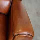 Set of 2 very comfortable large sheepskin armchairs elegantly finished with black piping