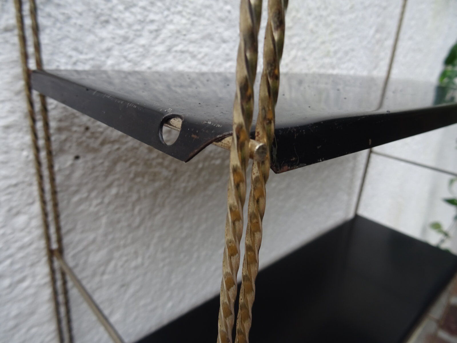 Metal thong wall shelf