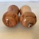 Salt and pepper shakers in wood shaped like a champagne cork.