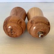 Salt and pepper shakers in wood shaped like a champagne cork.