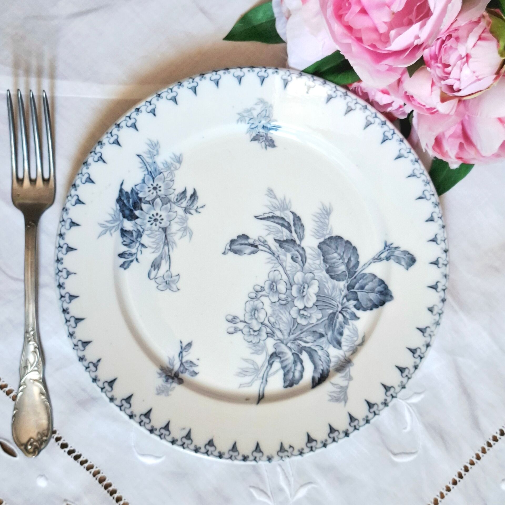 Old mismatched flat plates made of ironstone earthenware.