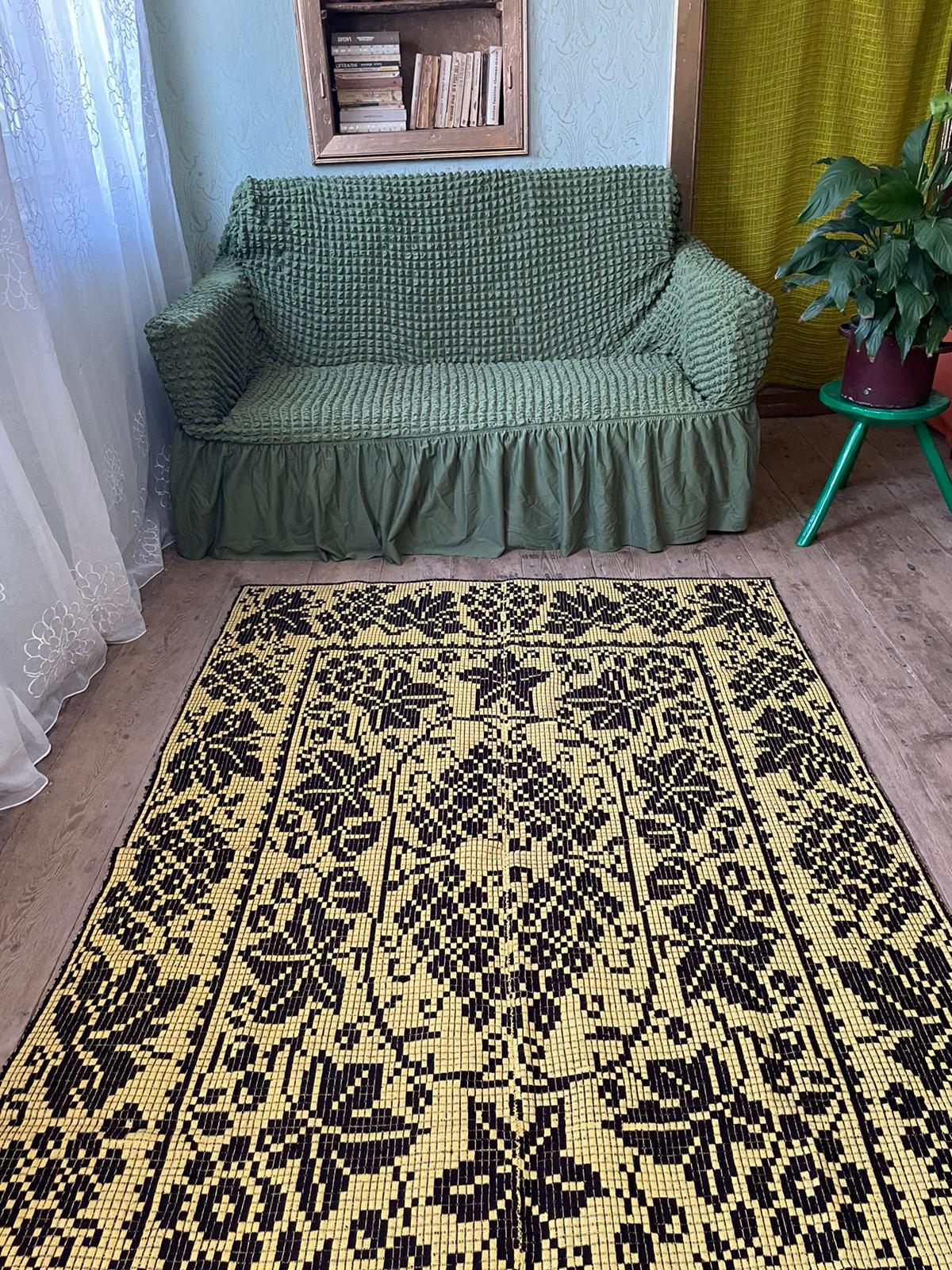 Romanian floral rug handwoven in wool, yellow and black background