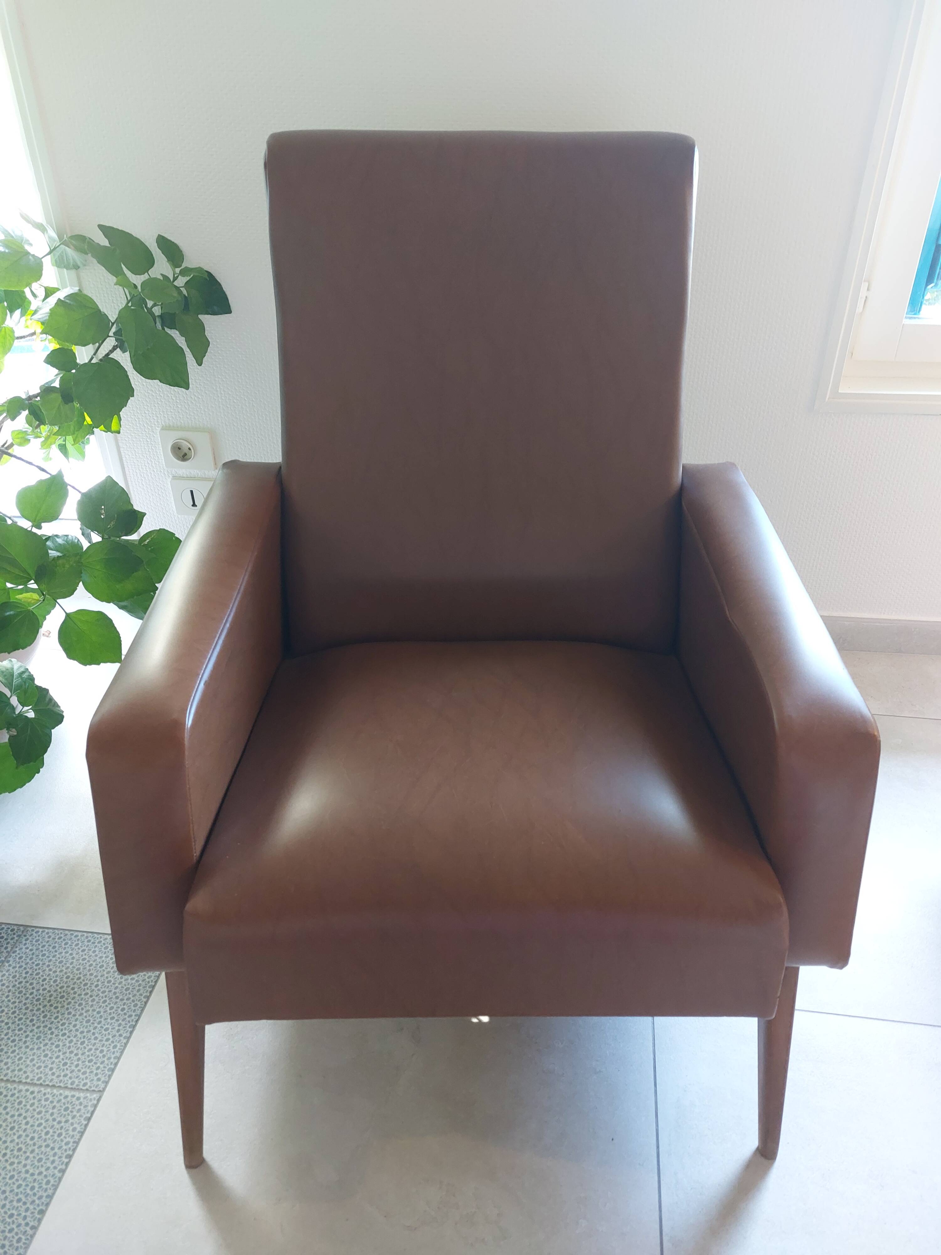 a pair of comfortable vintage armchairs with splayed legs