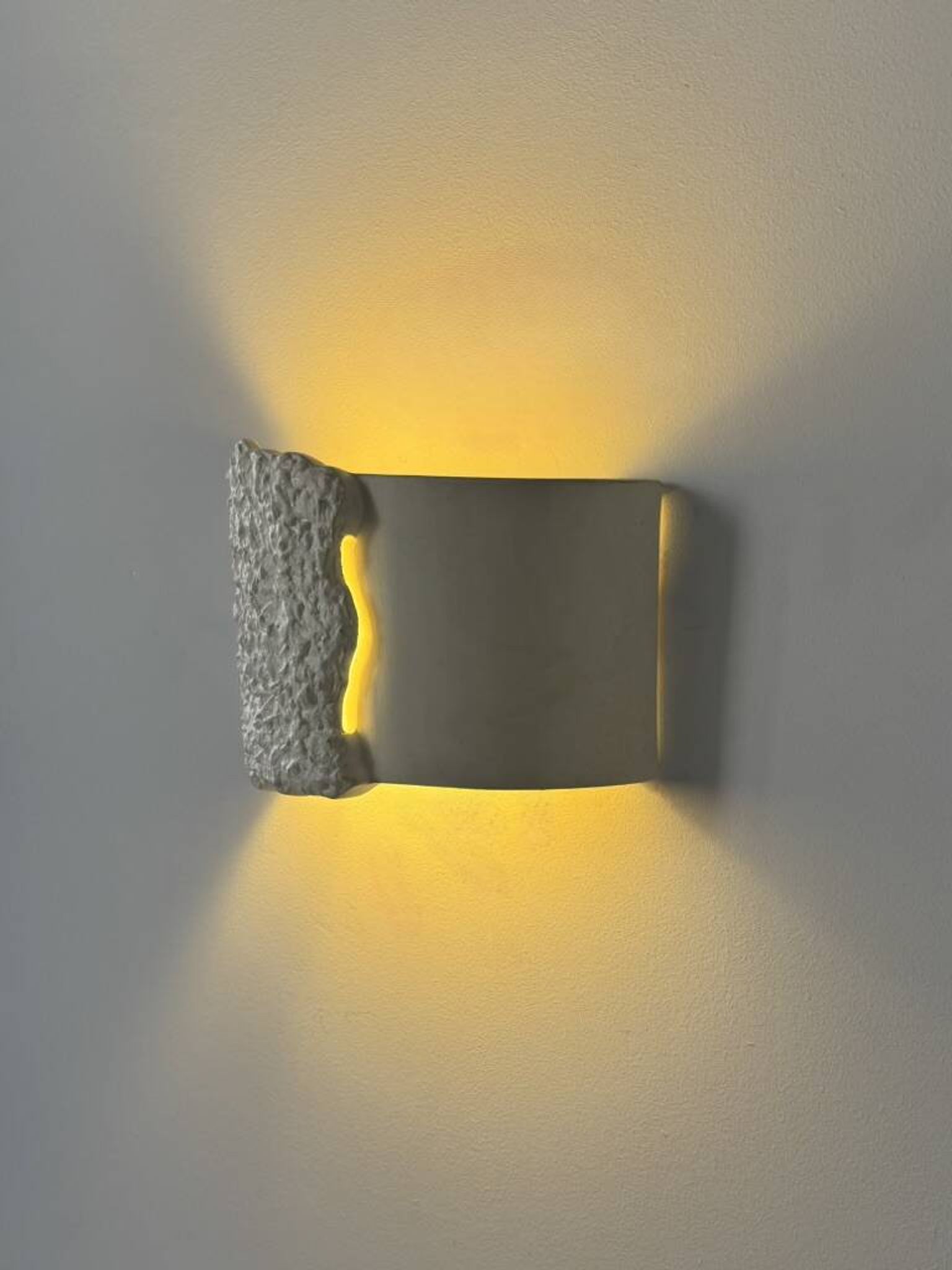 Pair of vintage wall lights in smooth plaster and stone imitation, France, 1970.