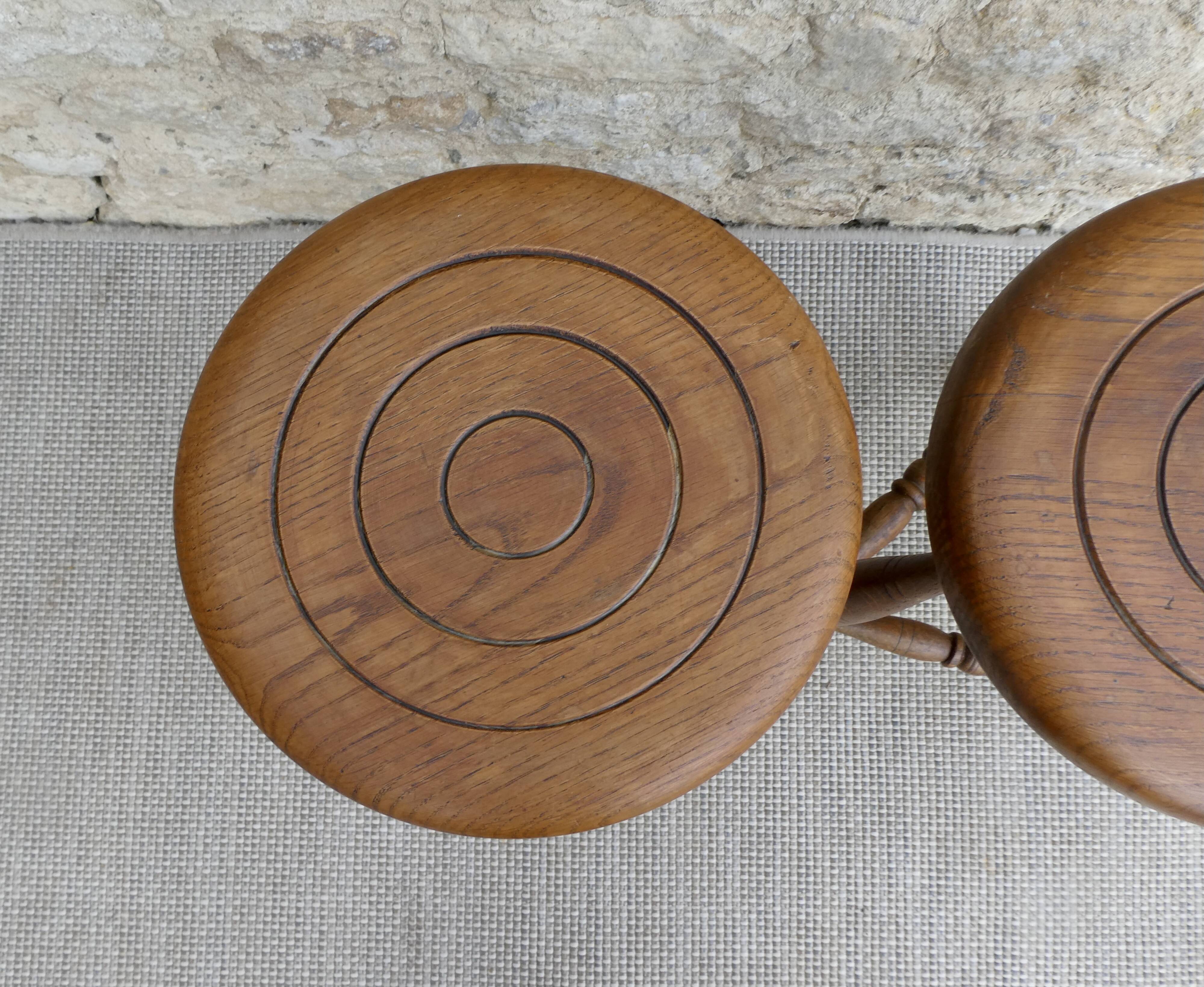 Pair of solid wood tripod stools, carved.