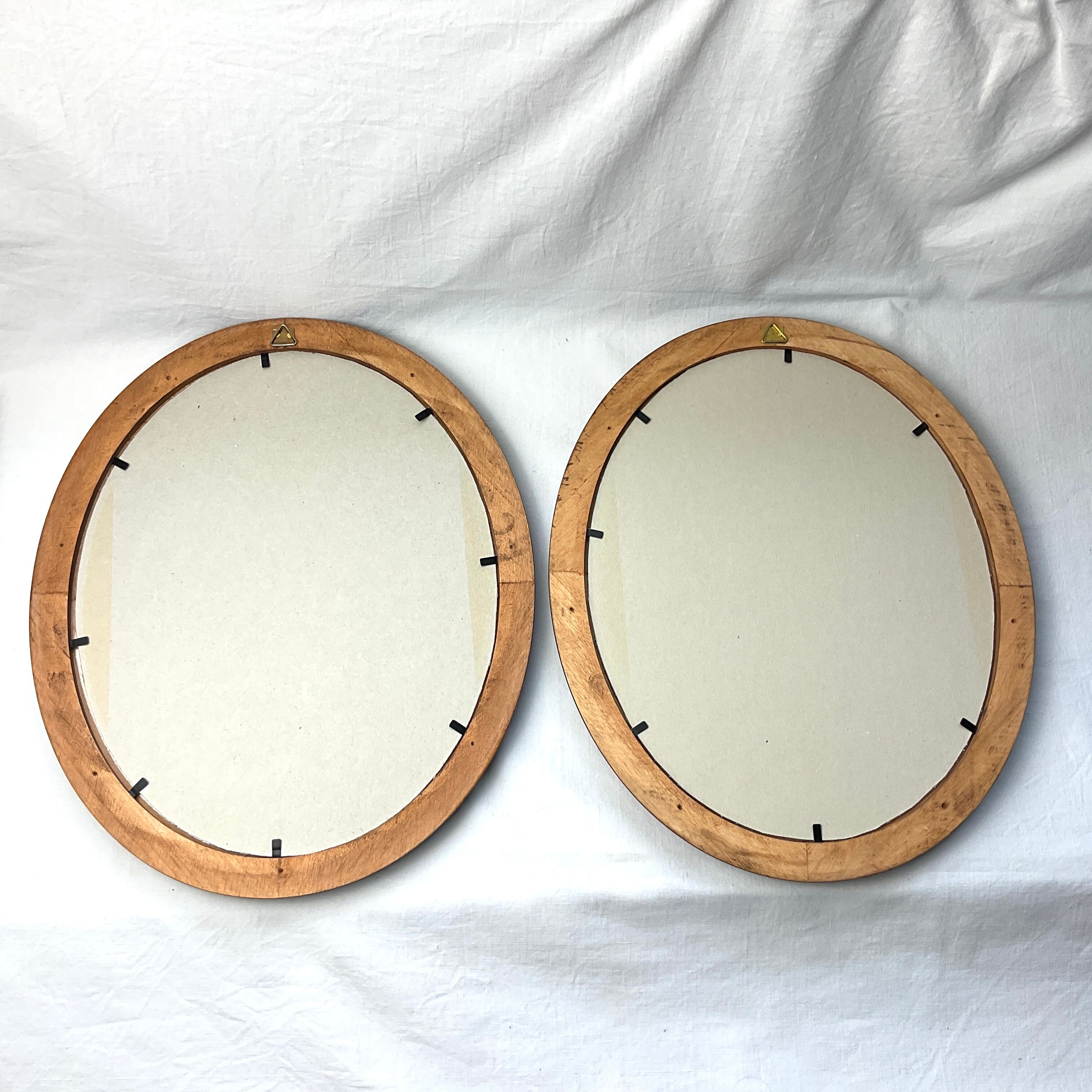 Pair of oval wooden frames with gilding