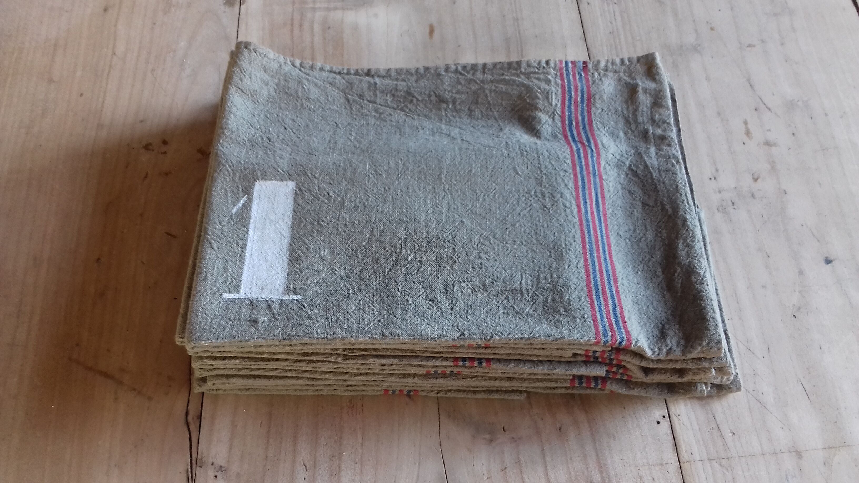 10 numbered khaki tea towels