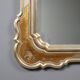 Antique mirror with a gilded frame and floral decorations, Italy, 20th century.