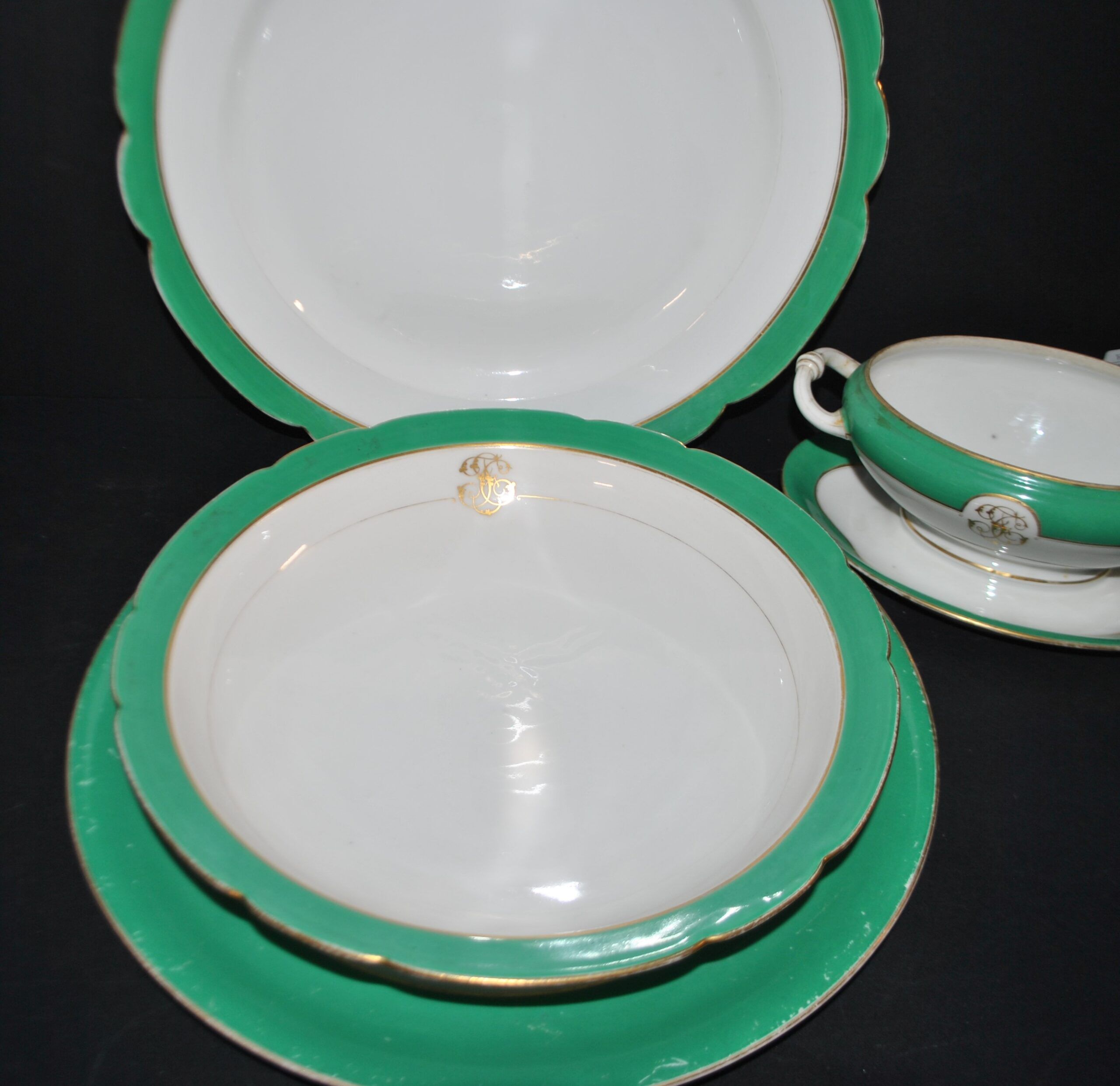 Paris porcelain set of 3 plates and a sauce boat with green border and gold monogram JC.