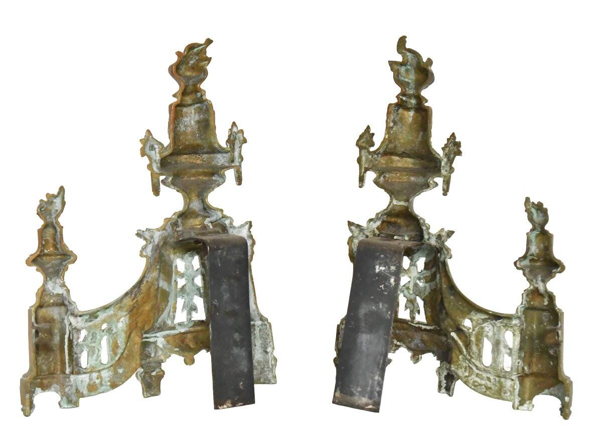 Pair of gilded brass fire dogs decorated with fire pots in the Louis XVI style.