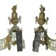 Pair of gilded brass fire dogs decorated with fire pots in the Louis XVI style.
