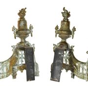 Pair of gilded brass fire dogs decorated with fire pots in the Louis XVI style.