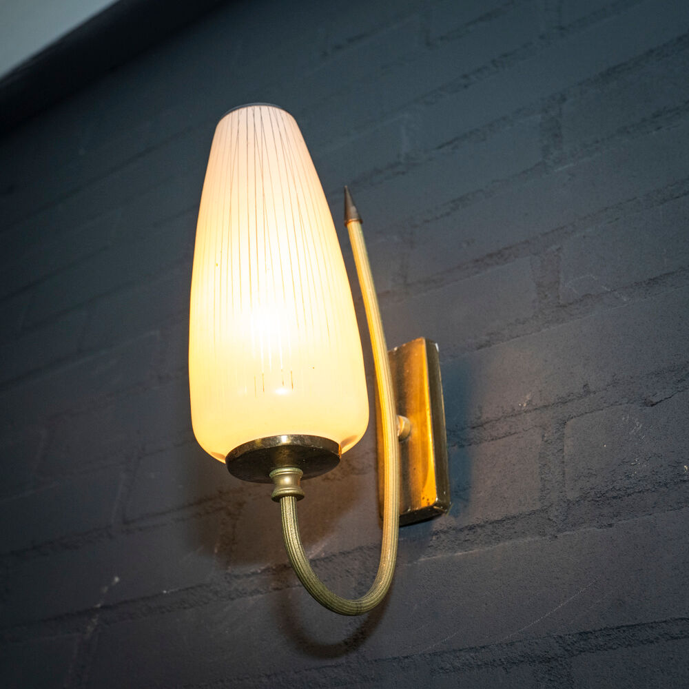 Ornate wall lamp made of milk glass and brass