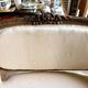 Two-seater basket bench in carved wood and beige mixed fabric, 18th century.