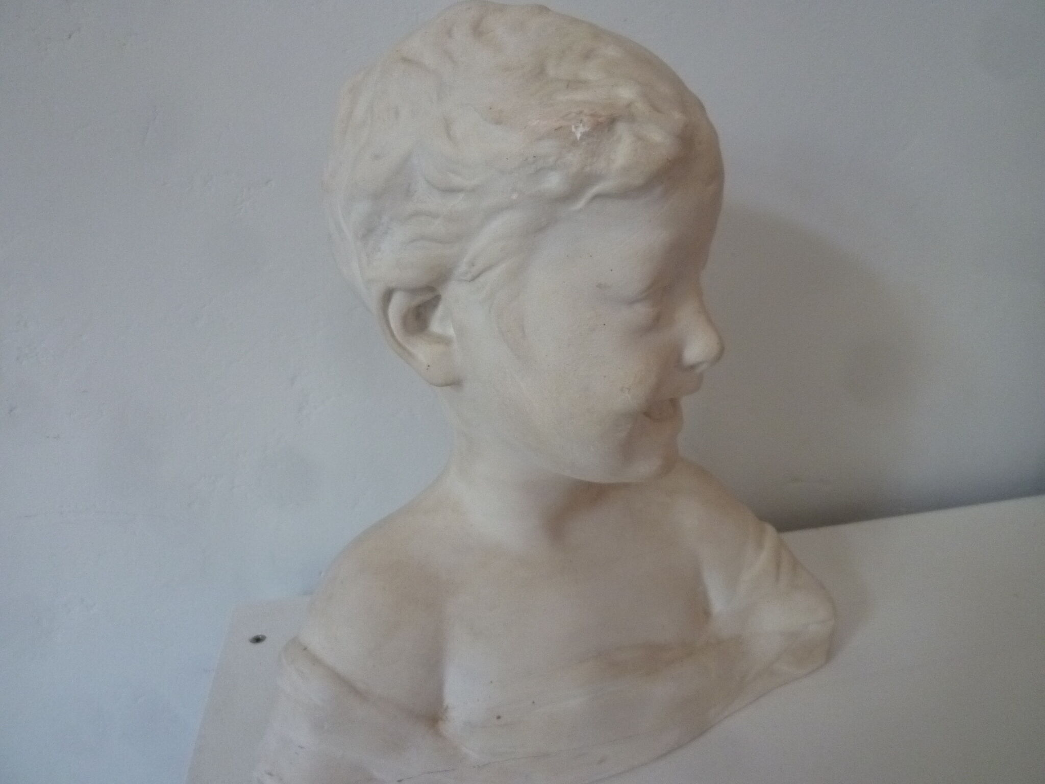 Bust young boy in plaster